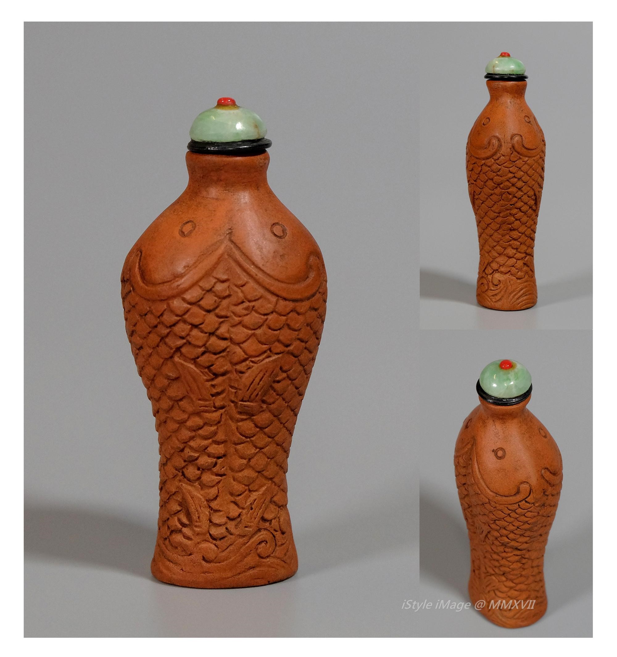 <br><h4>Lot 61 : An interesting and rare 'Song' style twinned brownish-orangey glazed 'fish' snuff bottle.  (Republic period)</h4>
							This 'Song' style interesting twinned 'fish' brownish-orangey glazed bottle, finely carved with two scaly fishes. With green jade stoppers, and spoon. 
							<br>Measurements (H) high 8 CM,  (W)width 3.3 CM<br><br><br>有趣和罕見的 '宋式風格' 棕橙色釉相連成對'魚'煙壺(民國時期)<br>這個有趣的'宋式風格棕橙色的相連成對'魚' 煙壺，精美雕刻兩尾鱗魚。 配綠玉塞子和勺子。<br>尺寸(H)高 8 厘米, (W)濶 3.3 厘米