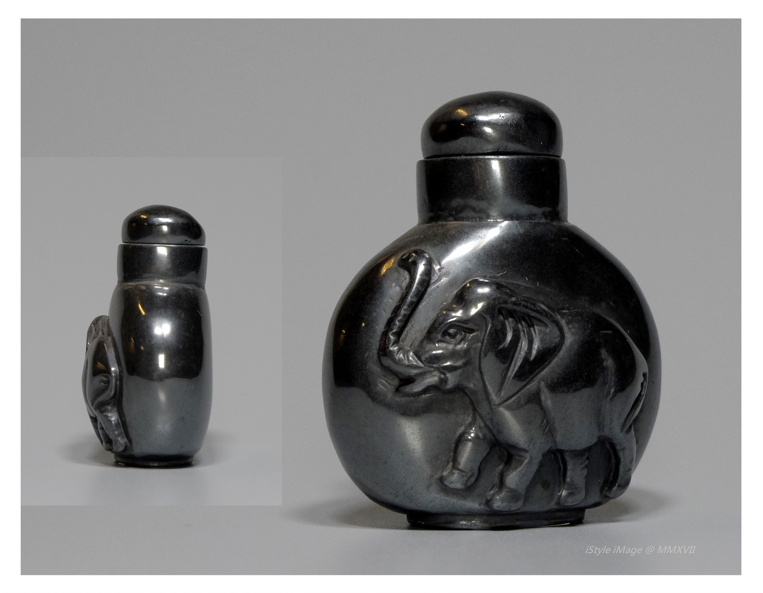 <br><h4>Lot 64 : A classic flattened ovoid shaped silver black tone hematite snuff bottle (70's last century)</h4>
							This flattened ovoid shaped silver black tone hematite carved with 
a lovely happy dancing elephant. With hematite stopper, and spoon. 
							<br>Measurements (H) high 5.2 CM, (T) thick 2.2 CM, (w)width 4.3CM<br><br><br>經典的扁平卵形銀黑色赤鐵礦石煙壺 (上世紀70年代)<br>這扁平的卵形銀黑色赤鐵礦石煙壺，雕刻著一可愛的快樂跳舞大象。 配赤鐵礦塞和勺子。<br>尺寸(H)高 5.2 厘米, (T)深 2.2 厘米, (W)濶 4.3 厘米